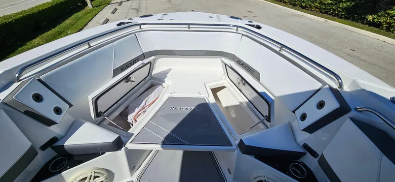 Slide: The Image of 2020 Blackfin 272 CC boat interior with open storage compartments and seating. - 9