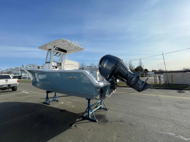 Slide: The Image of 2022 Sea Hunt Ultra 239 SE boat on stands in a parking lot. - 1