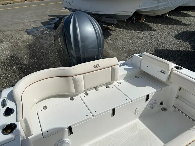 Slide: The Image of 2022 Sea Hunt Ultra 239 SE boat interior with seating and storage compartments. - 10