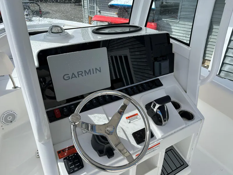 Slide: The Image of 2022 Sea Hunt Ultra 239 SE boat dashboard with Garmin navigation system and steering wheel. - 13