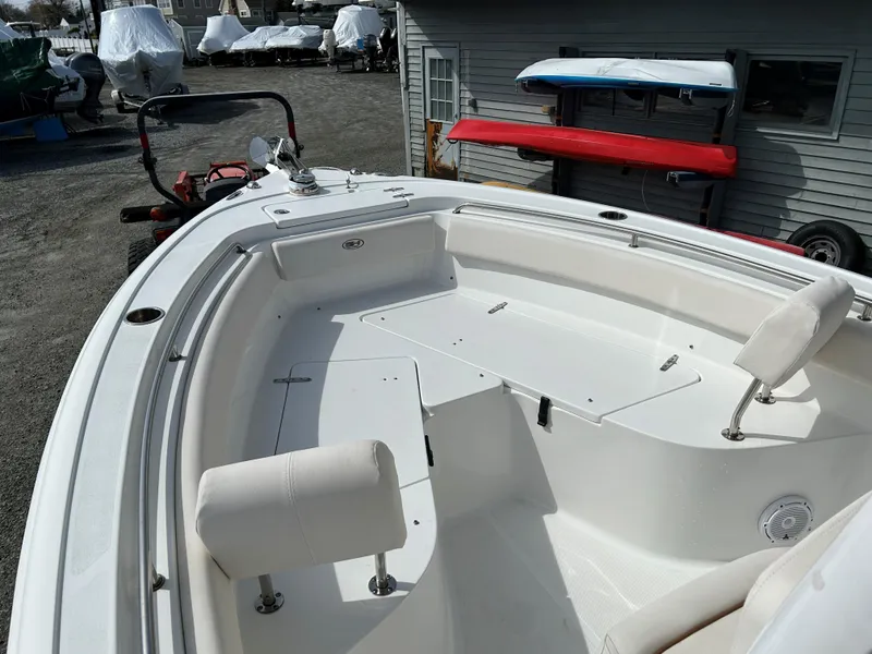 Slide: The Image of 2022 Sea Hunt Ultra 239 SE boat interior with seating and storage compartments. - 14