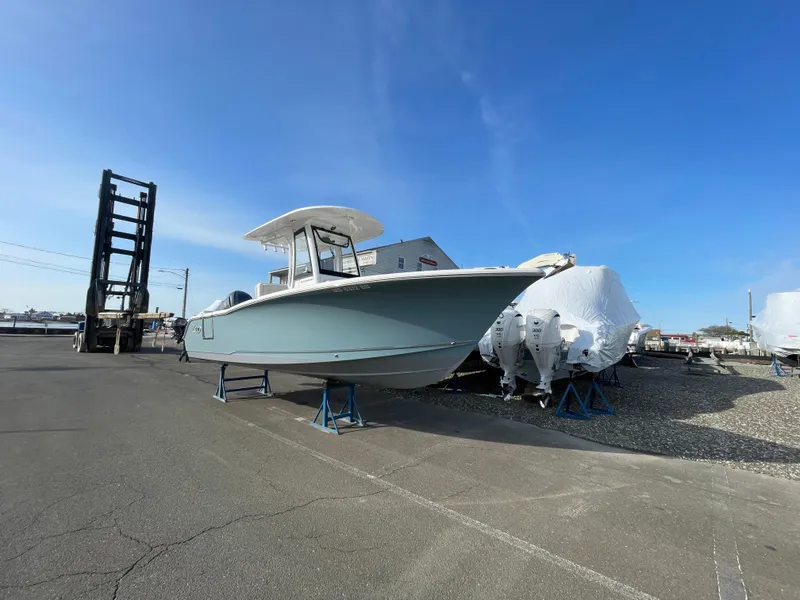 Slide: The Image of 2022 Sea Hunt Ultra 239 SE boat on display in a marina. - 19
