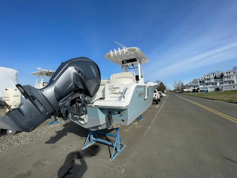 Slide: The Image of 2022 Sea Hunt Ultra 239 SE boat with outboard motor on a sunny day. - 20