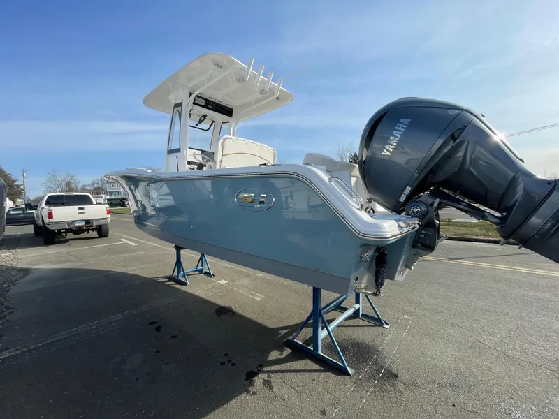 Slide: The Image of 2022 Sea Hunt Ultra 239 SE boat on stands, featuring a Yamaha outboard motor. - 21