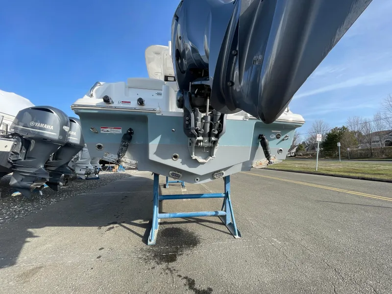 Slide: The Image of 2022 Sea Hunt Ultra 239 SE boat on stand, rear view with outboard motor. - 22