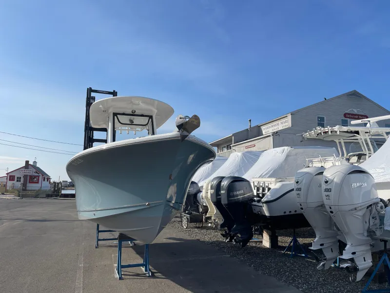 Slide: The Image of 2022 Sea Hunt Ultra 239 SE boat displayed outdoors with multiple outboard engines. - 23