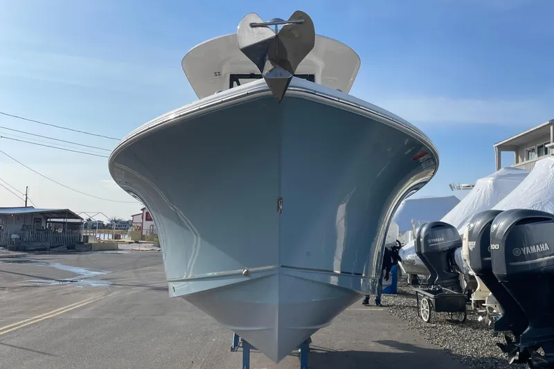 Slide: The Image of 2022 Sea Hunt Ultra 239 SE boat, front view, parked with Yamaha engines visible. - 24