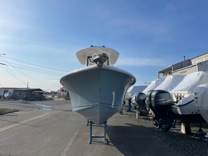 Slide: The Image of 2022 Sea Hunt Ultra 239 SE boat on display at a marina. - 4