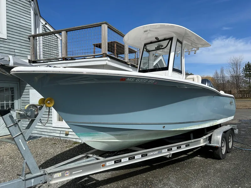 Slide: The Image of 2022 Sea Hunt Ultra 239 SE boat on trailer, parked outdoors. - 6