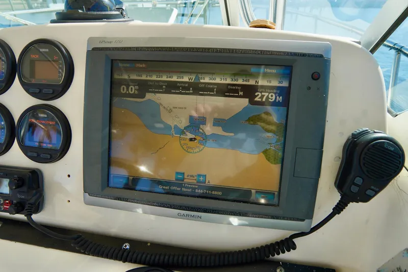 Slide: The Image of Garmin GPS system on 2003 Pursuit 3070 Express boat dashboard with navigation display. - 14
