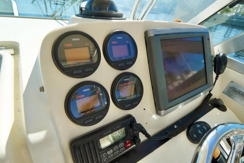 Slide: The Image of Dashboard of a 2003 Pursuit 3070 Express boat with gauges and navigation screen. - 15