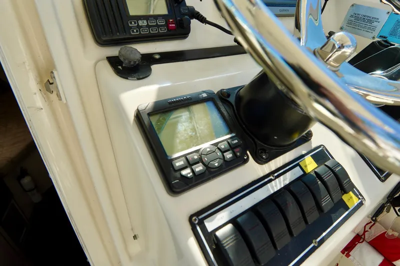 Slide: The Image of Control panel of a 2003 Pursuit 3070 Express boat with navigation equipment. - 17