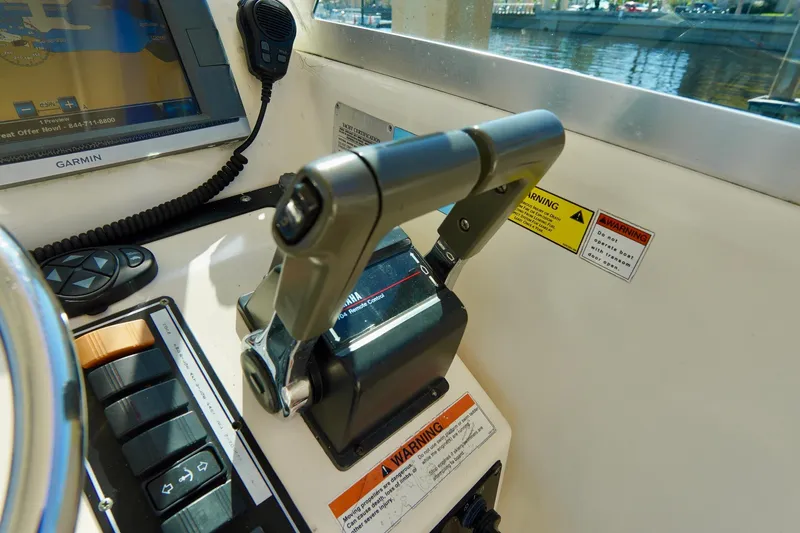 Slide: The Image of 2003 Pursuit 3070 Express boat controls with throttle and navigation equipment. - 18