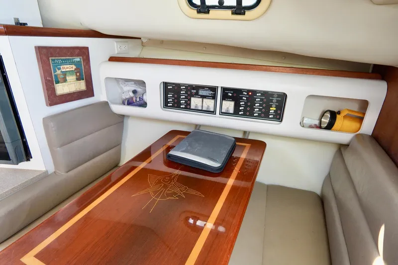 Slide: The Image of Interior of 2003 Pursuit 3070 Express boat with wood table and control panel. - 22