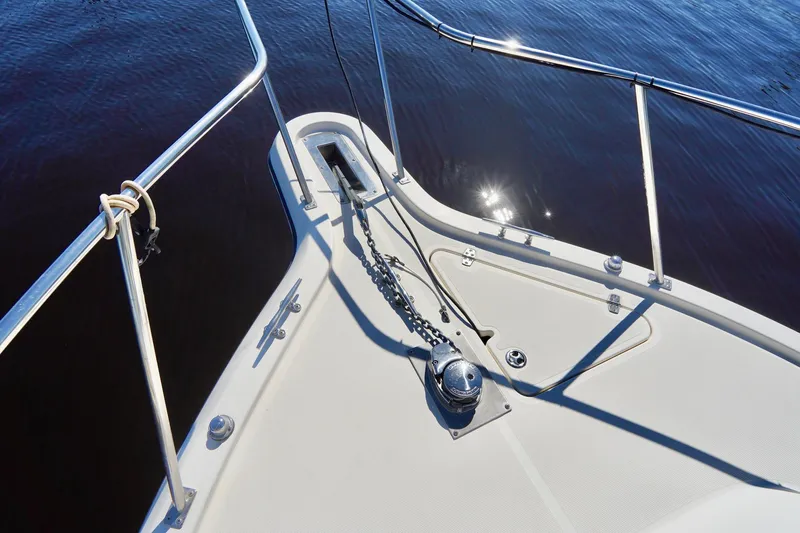 Slide: The Image of Bow of 2003 Pursuit 3070 Express boat with anchor chain and railing. - 3