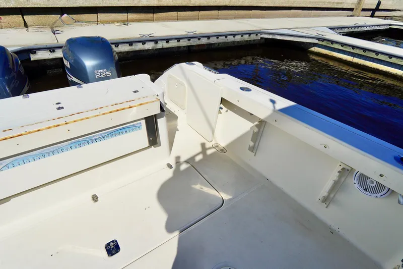Slide: The Image of 2003 Pursuit 3070 Express boat interior with Yamaha 225 engines at dock. - 38