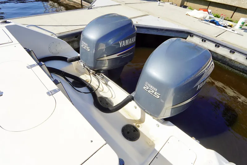 Slide: The Image of 2003 Pursuit 3070 Express boat with twin Yamaha 225 outboard engines at dock. - 39