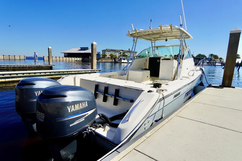 Slide: The Image of 2003 Pursuit 3070 Express boat docked with twin Yamaha engines. - 41