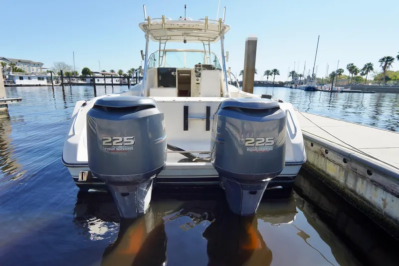 Slide: The Image of 2003 Pursuit 3070 Express boat with twin 225 horsepower engines docked at marina. - 42