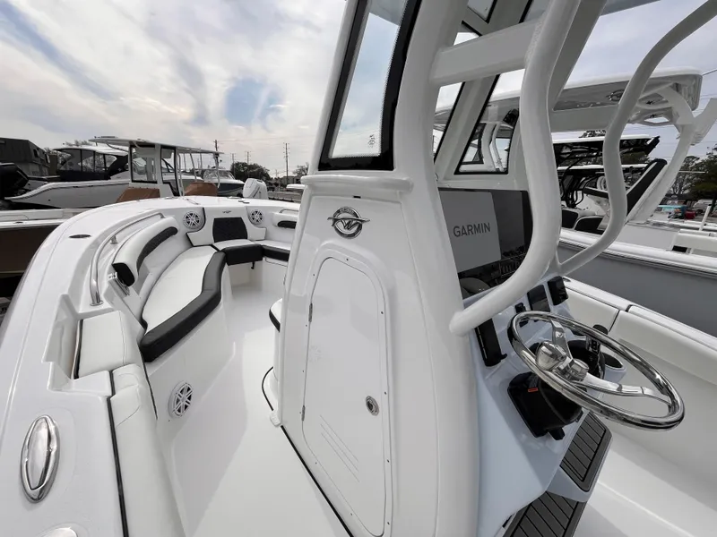 Slide: The Image of 2025 Tidewater 232 LXF boat interior with steering wheel and seating area. - 10