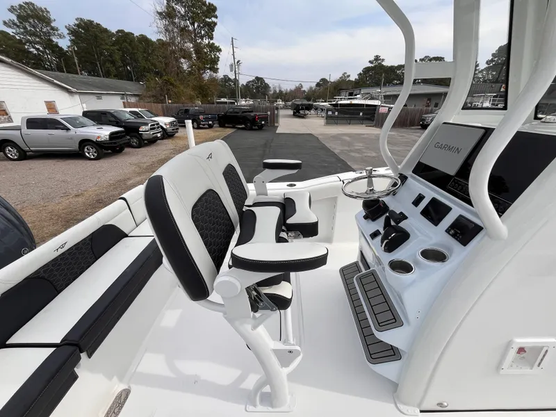 Slide: The Image of 2025 Tidewater 232 LXF boat interior with modern helm and seating. - 15