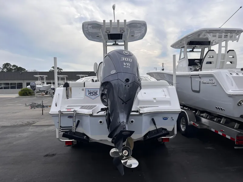 Slide: The Image of 2025 Tidewater 232 LXF boat with 300 V6 engine, displayed in a marina. - 4
