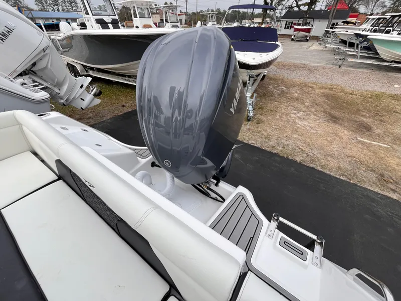 Slide: The Image of 2025 Tidewater 232 LXF boat with Yamaha outboard motor, displayed in a marina setting. - 5