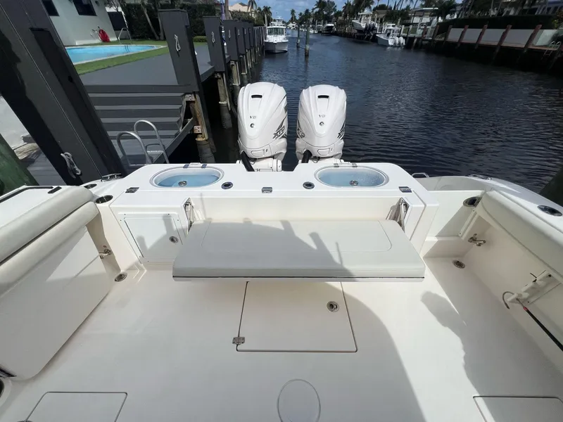 Slide: The Image of 2020 Cobia 350 boat with dual engines docked by a canal. - 14