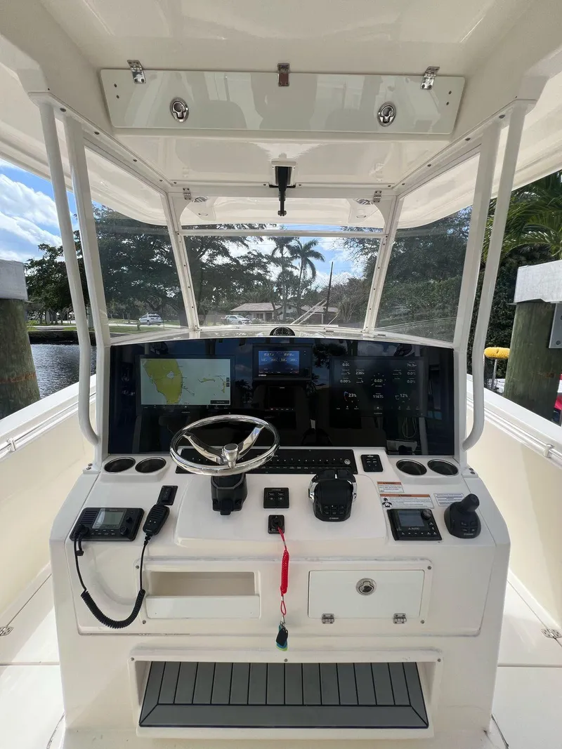 Slide: The Image of 2020 Cobia 350 boat helm with advanced navigation system and steering wheel. - 5