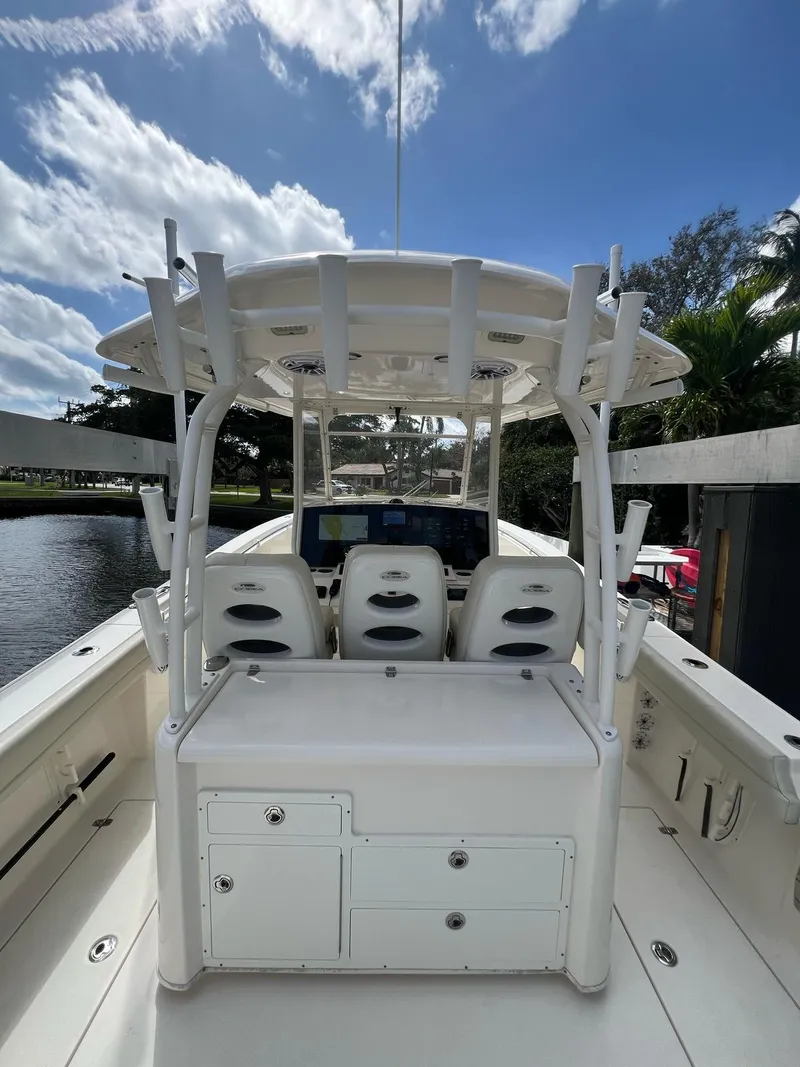 Slide: The Image of 2020 Cobia 350 boat interior with helm station, white seating, and clear sky background. - 6