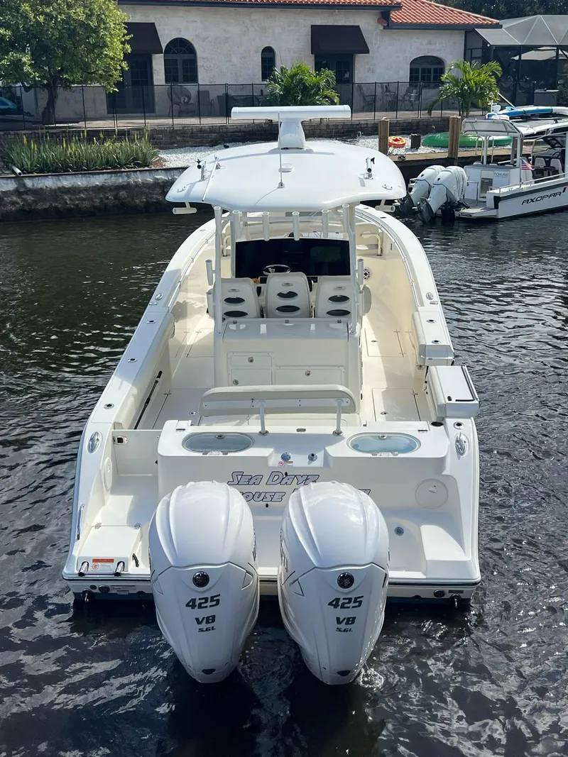 Slide: The Image of 2020 Cobia 350 boat with twin 425 V8 engines docked in a marina. - 8