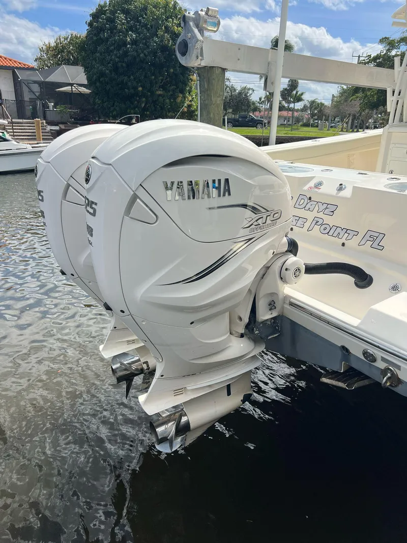 Slide: The Image of 2020 Cobia 350 with twin Yamaha outboard engines docked in a marina. - 9