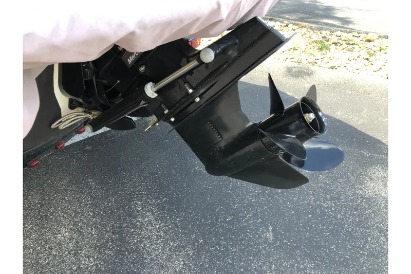 Slide: The Image of 2011 Sea Ray 195 Sport boat propeller and outdrive on pavement. - 2