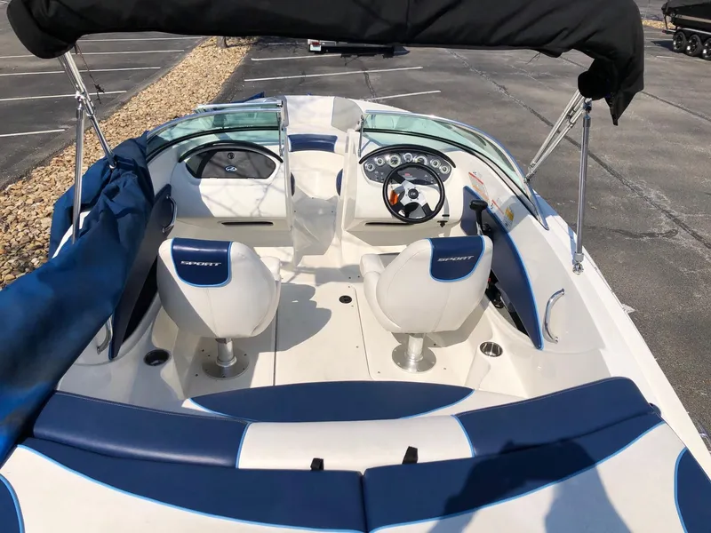 Slide: The Image of 2011 Sea Ray 195 Sport boat interior with blue and white seating and dashboard. - 3