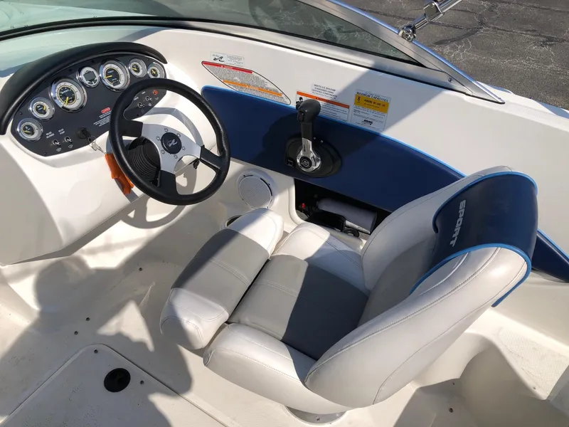 Slide: The Image of Interior of 2011 Sea Ray 195 Sport boat, featuring steering wheel and control panel. - 4