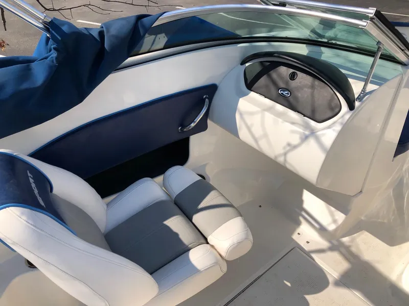 Slide: The Image of 2011 Sea Ray 195 Sport boat interior with white and blue seating. - 5