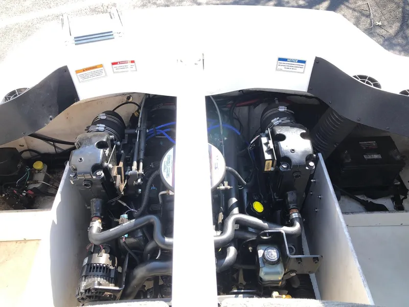 Slide: The Image of 2011 Sea Ray 195 Sport engine compartment with dual engines visible. - 9