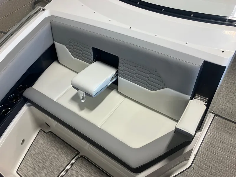 Slide: The Image of 2025 Cobalt A29 boat interior with gray and white seating and cup holders. - 13