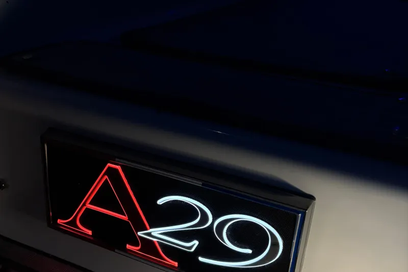 Slide: The Image of 2025 Cobalt A29 illuminated logo in red and white on a dark background. - 29
