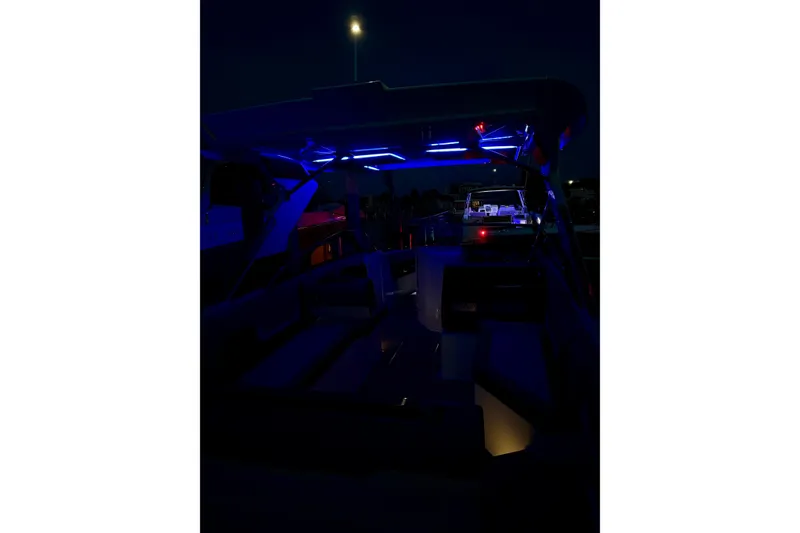 Slide: The Image of 2025 Cobalt A29 boat interior with blue LED lighting at night. - 30