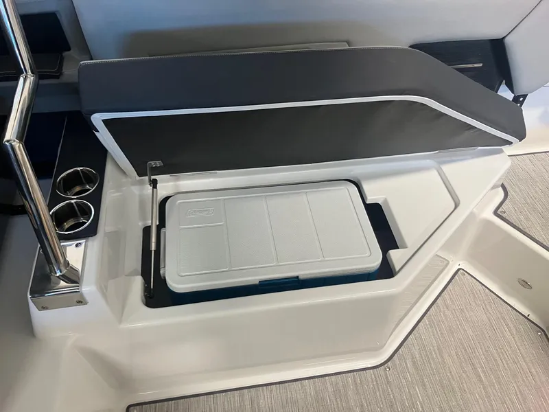 Slide: The Image of 2025 Cobalt A29 boat interior with built-in cooler and cup holders. - 6