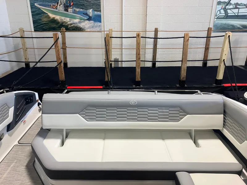Slide: The Image of 2025 Cobalt A29 boat interior with gray and white seating, displayed indoors. - 7
