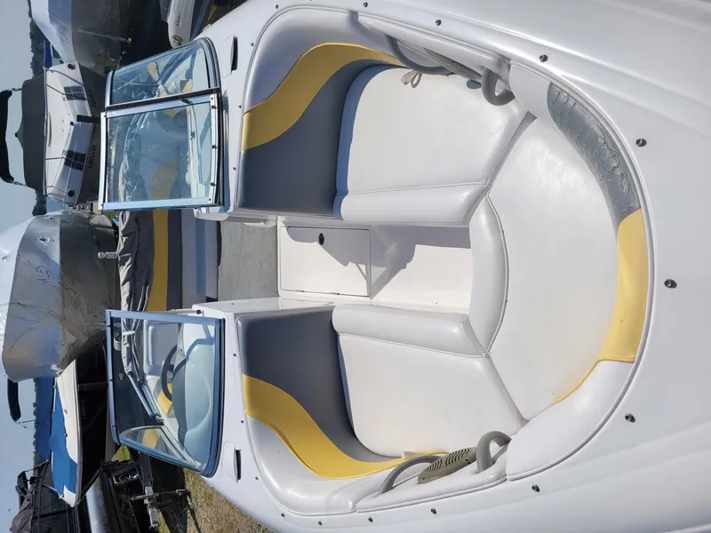 Slide: The Image of 2002 Moomba Outback LSV boat interior with white and yellow seating. - 10