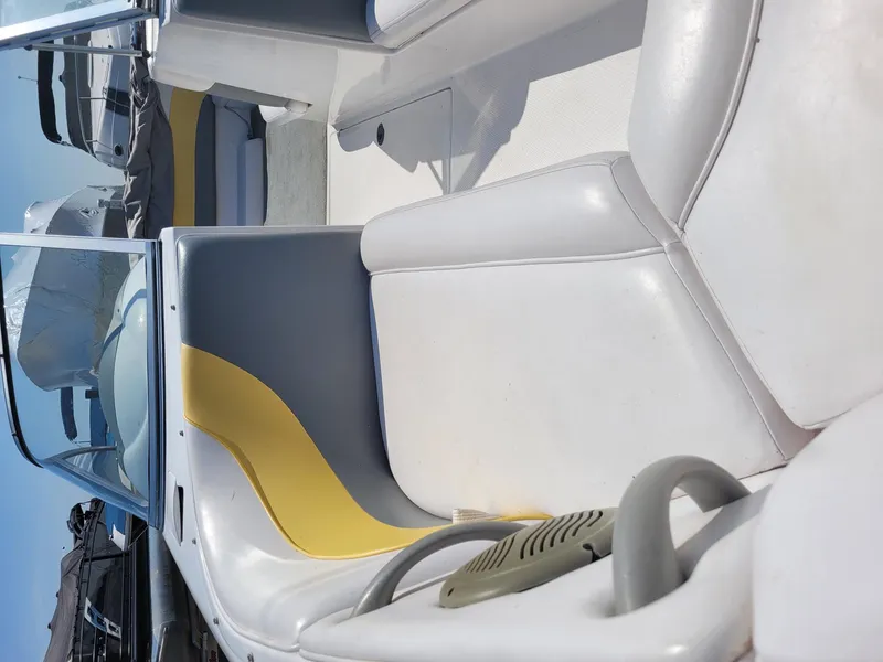 Slide: The Image of Interior of a 2002 Moomba Outback LSV boat with white and yellow seating. - 11