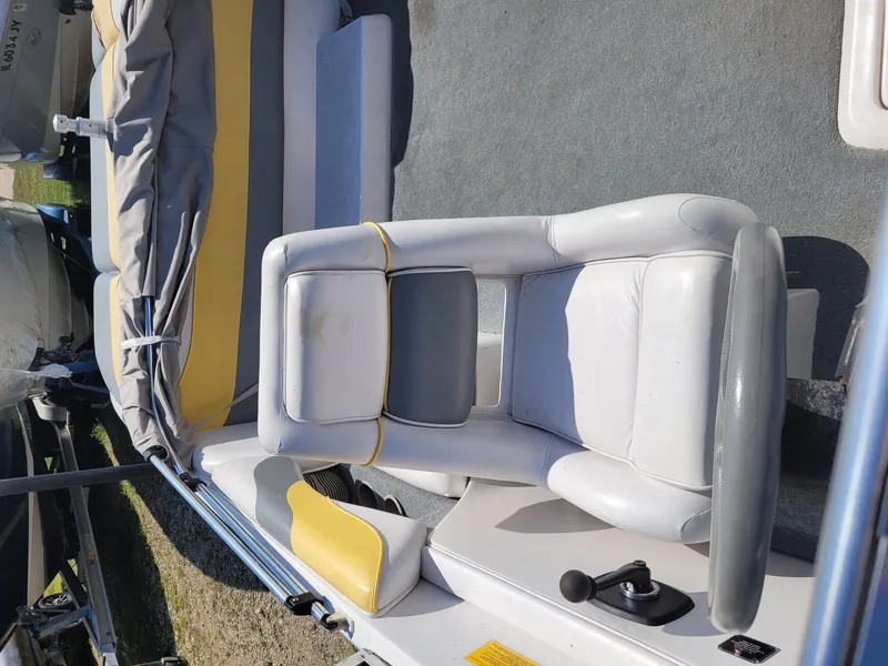 Slide: The Image of 2002 Moomba Outback LSV boat interior with white and yellow seating. - 14