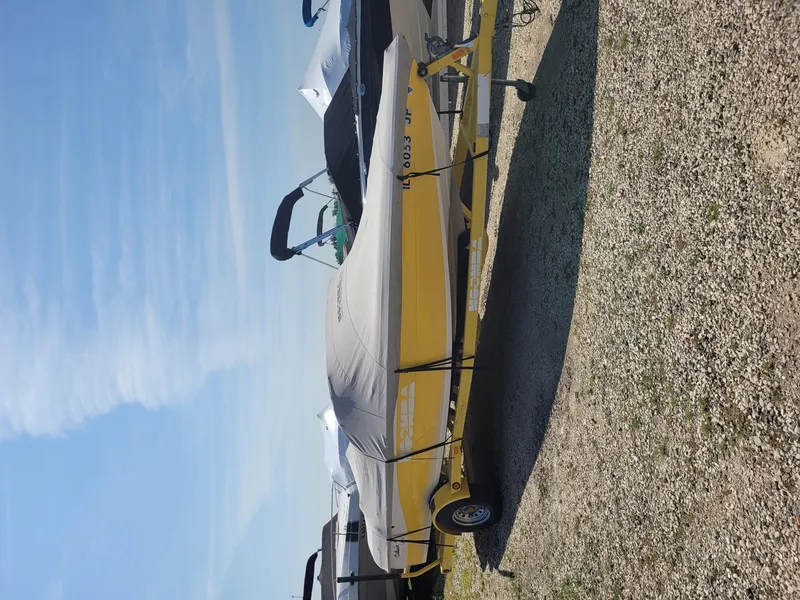 Slide: The Image of 2002 Moomba Outback LSV boat with cover on trailer, parked on gravel. - 16