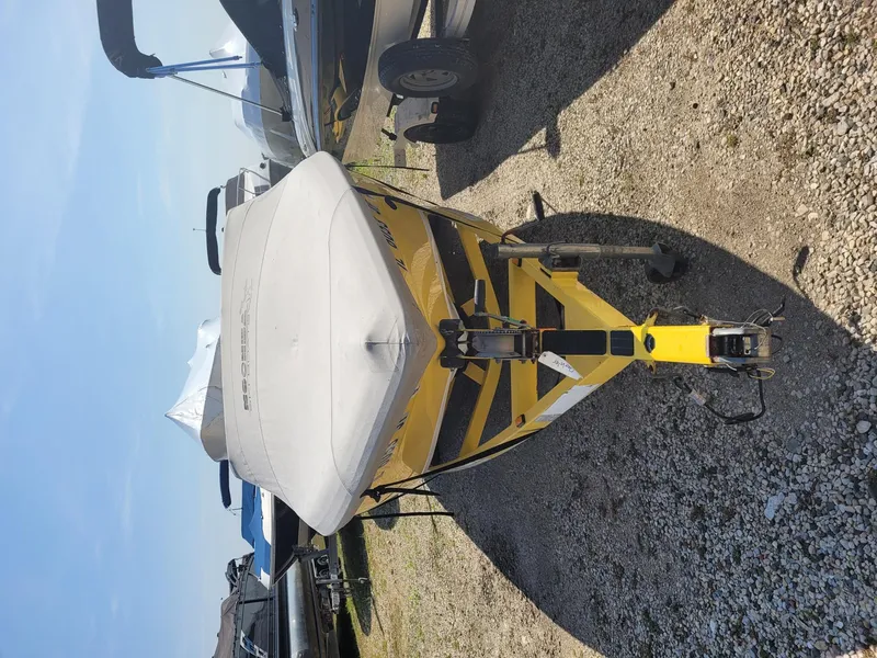 Slide: The Image of 2002 Moomba Outback LSV boat on trailer, covered, parked on gravel. - 17