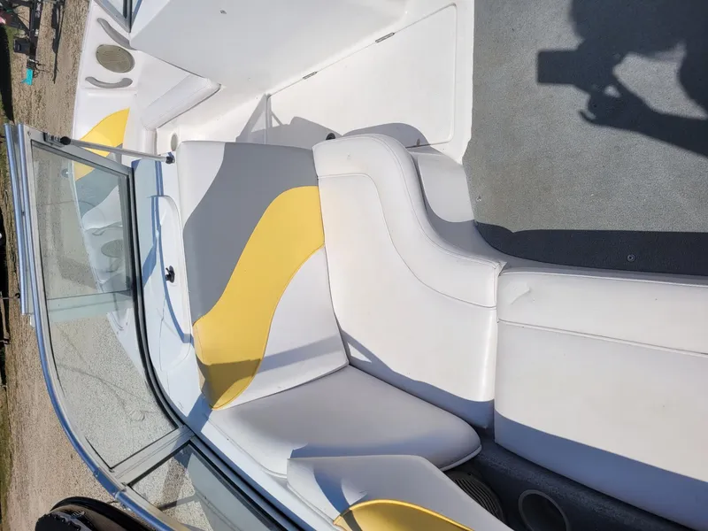 Slide: The Image of 2002 Moomba Outback LSV boat interior with white and yellow seating. - 6