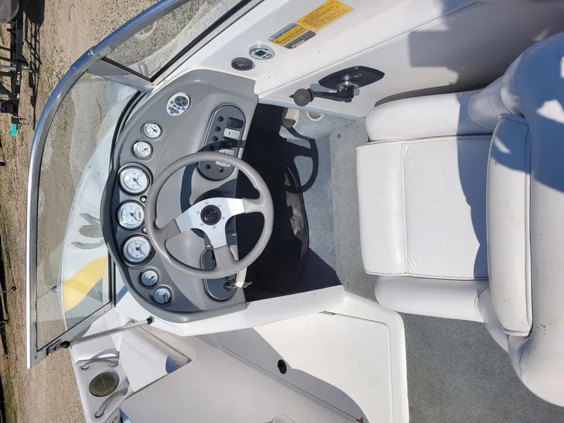 Slide: The Image of 2002 Moomba Outback LSV boat interior with steering wheel and dashboard controls. - 7