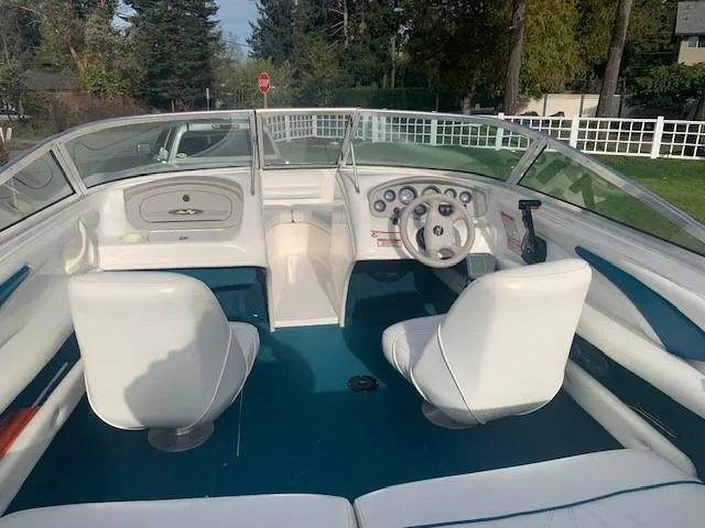 Slide: The Image of 1998 Sea Ray 185 Bow Rider interior with white seats and blue flooring. - 4